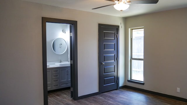 4603 N Tom Green Ave, Odessa, TX 79762 - unfurnished bedroom featuring dark wood-style floors, ensuite bath, and ceiling fan