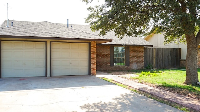 4603 N Tom Green Ave, Odessa, TX 79762 - view of front of property featuring brick siding, roof with shingles, an attached garage, and concrete driveway