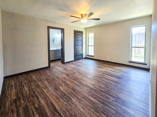 4603 N Tom Green Ave, Odessa, TX 79762 - empty room with dark wood finished floors, plenty of natural light, and a ceiling fan