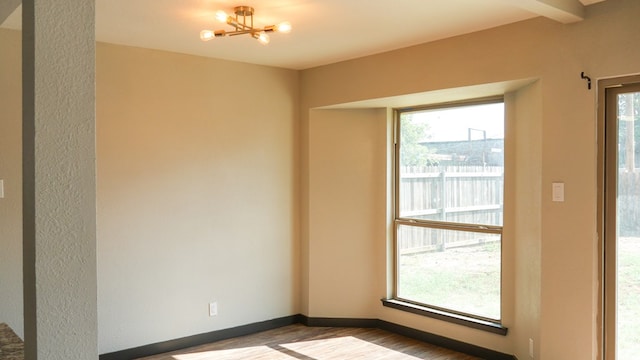 4603 N Tom Green Ave, Odessa, TX 79762 - spare room with a chandelier and wood finished floors