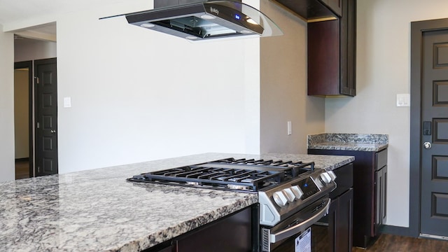 4603 N Tom Green Ave, Odessa, TX 79762 - kitchen with range hood, gas stove, dark wood finished floors, dark brown cabinetry, and light stone countertops