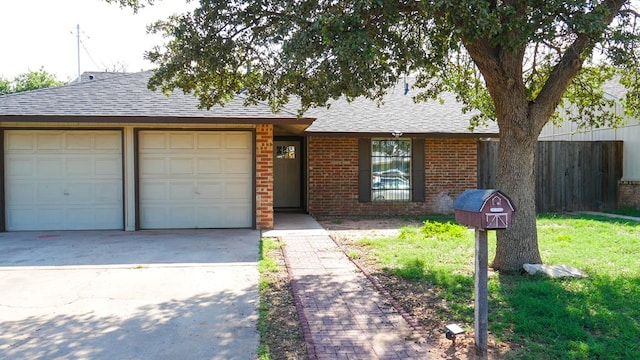 4603 N Tom Green Ave, Odessa, TX 79762 - view of front of property with a garage, a shingled roof, driveway, and brick siding