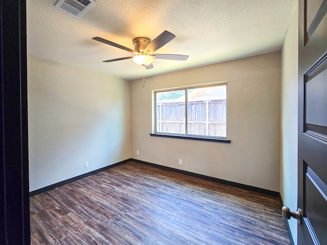 4603 N Tom Green Ave, Odessa, TX 79762 - empty room featuring dark wood-style floors, a textured ceiling, and ceiling fan