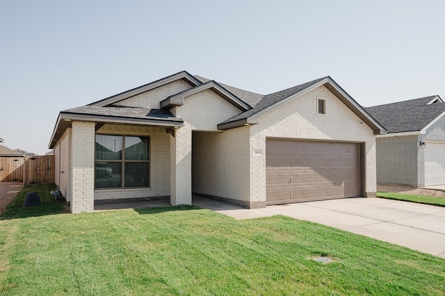 909 Canal St, Odessa, TX 79765 - view of front of property featuring a garage, brick siding, driveway, and roof with shingles