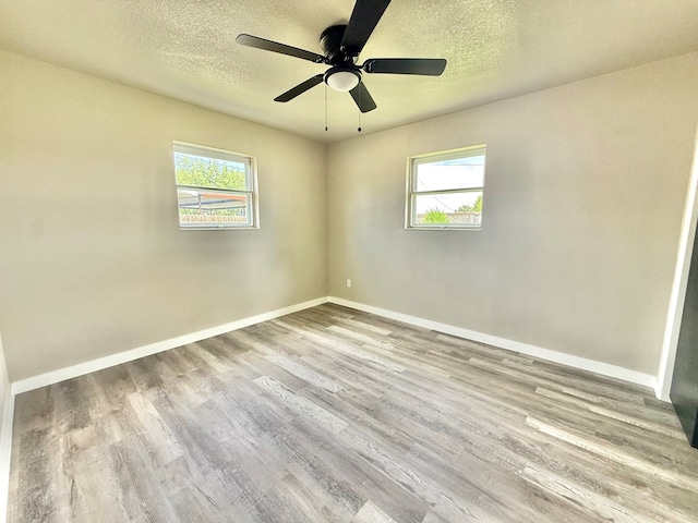 2410 E 25th St, Odessa, TX 79762 - unfurnished room with wood finished floors, baseboards, a textured ceiling, and a ceiling fan