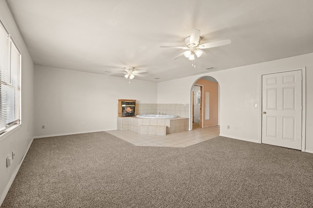 4530 W Morris St, Odessa, TX 79764 - unfurnished living room with ceiling fan, light colored carpet, arched walkways, and baseboards