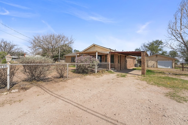 4530 W Morris St, Odessa, TX 79764 - view of front of house featuring brick siding, driveway, a detached garage, and cooling unit