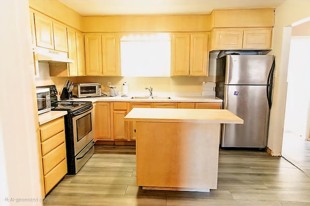 3703 N Jackson Ave, Odessa, TX 79762 - kitchen featuring appliances with stainless steel finishes, under cabinet range hood, light brown cabinetry, and light wood-style flooring