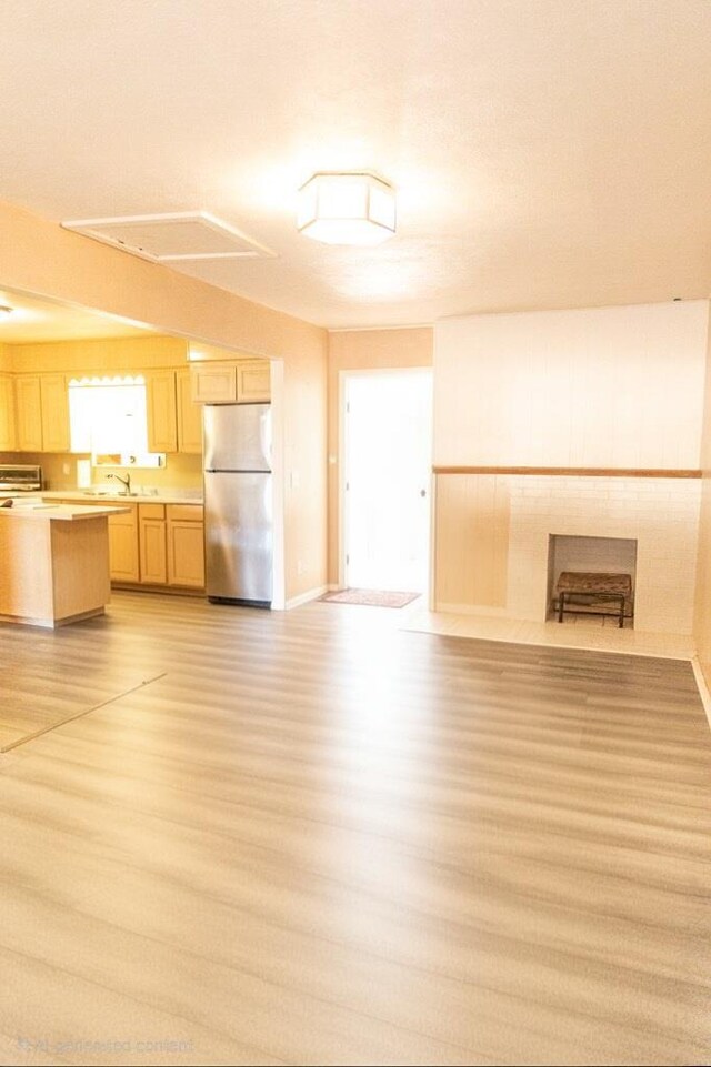 3703 N Jackson Ave, Odessa, TX 79762 - kitchen featuring freestanding refrigerator, open floor plan, light brown cabinetry, and light wood-type flooring