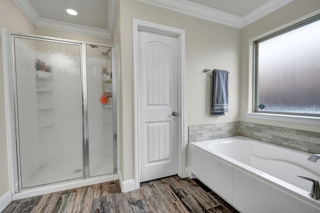 bathroom with independent shower and bath, crown molding, wood-type flooring, and a wealth of natural light