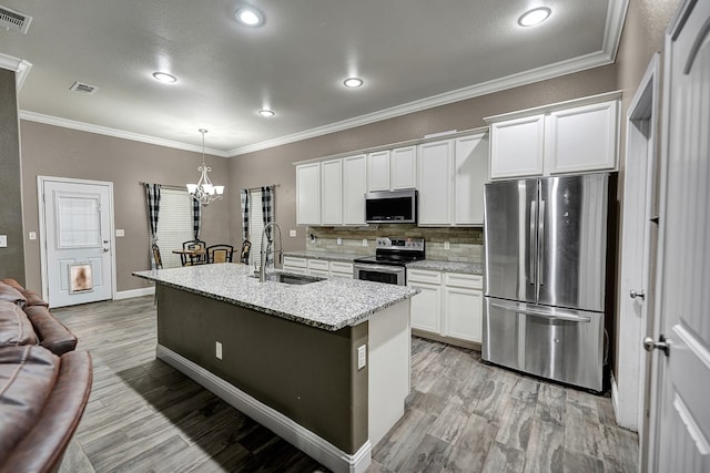 kitchen with appliances with stainless steel finishes, sink, and white cabinets