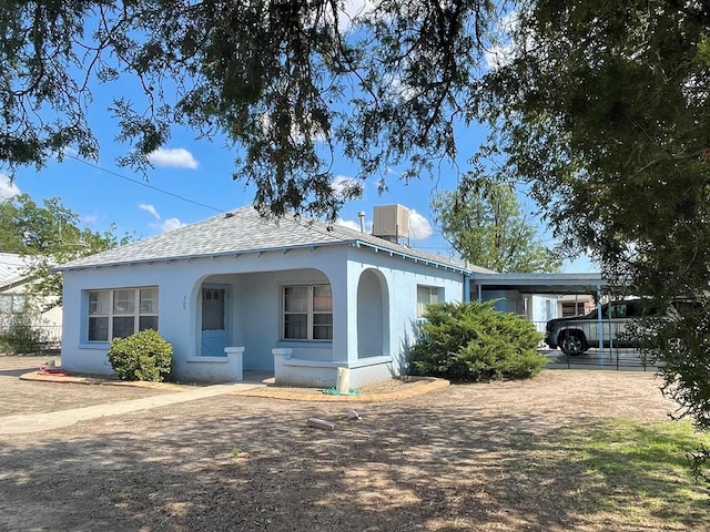 view of front of house with central AC unit, a porch, and a carport