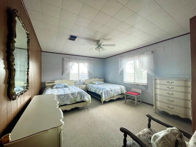 carpeted bedroom with multiple windows and ceiling fan