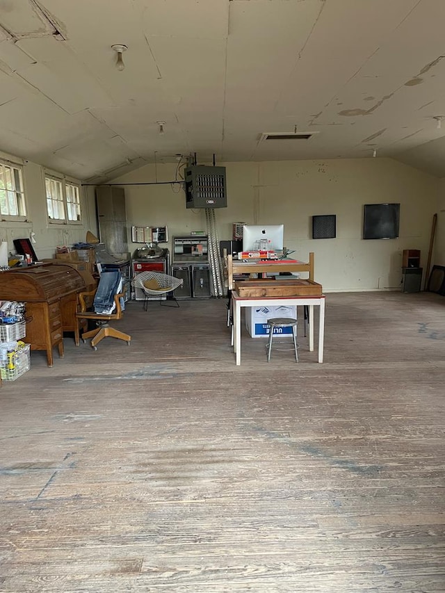 interior space with wood-type flooring and vaulted ceiling