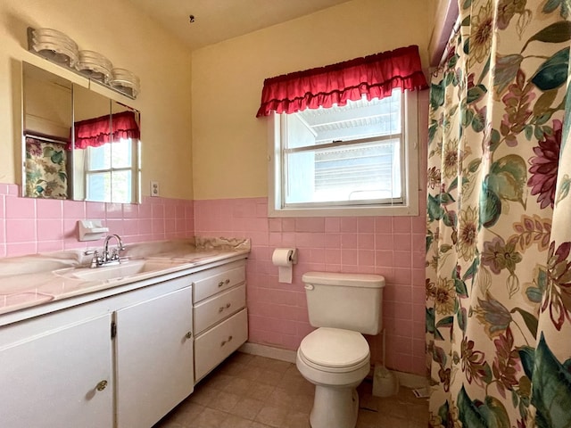 bathroom featuring vanity, tile patterned floors, a shower with shower curtain, toilet, and tile walls