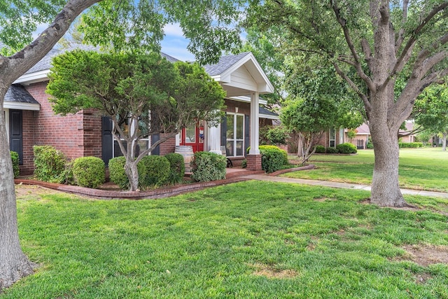 1000 S Nelson Rd, Monahans, TX 79756 - view of property hidden behind natural elements featuring brick siding, a front yard, and a shingled roof