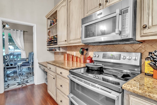 1000 S Nelson Rd, Monahans, TX 79756 - kitchen with appliances with stainless steel finishes, decorative backsplash, dark wood-style floors, and light stone counters