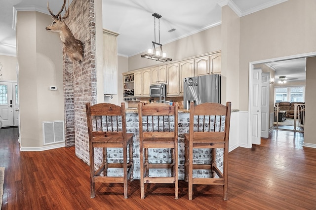1000 S Nelson Rd, Monahans, TX 79756 - dining space with dark wood-style flooring, ornamental molding, a high ceiling, and ceiling fan