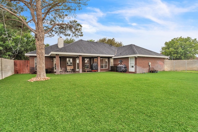 1000 S Nelson Rd, Monahans, TX 79756 - back of house with brick siding, a chimney, a fenced backyard, and a shingled roof