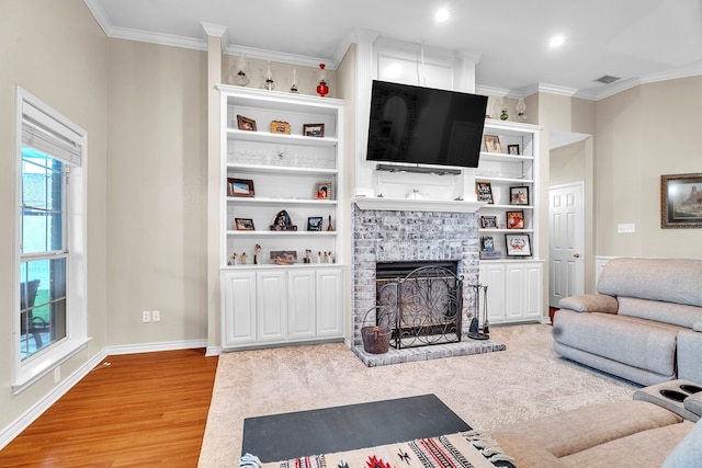1000 S Nelson Rd, Monahans, TX 79756 - living room featuring light wood finished floors, ornamental molding, a fireplace, and recessed lighting