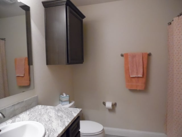 bathroom featuring vanity and toilet