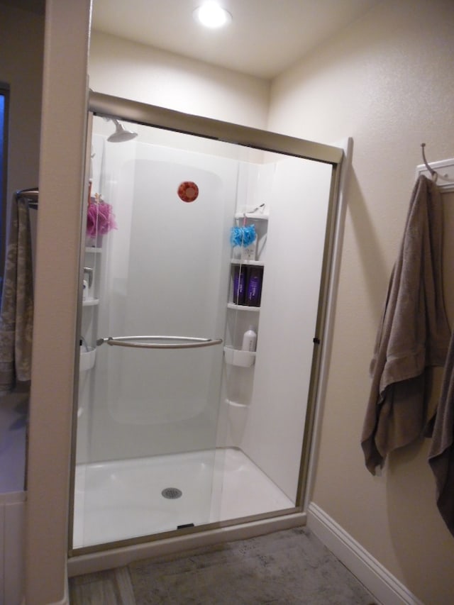 bathroom featuring a shower with shower door