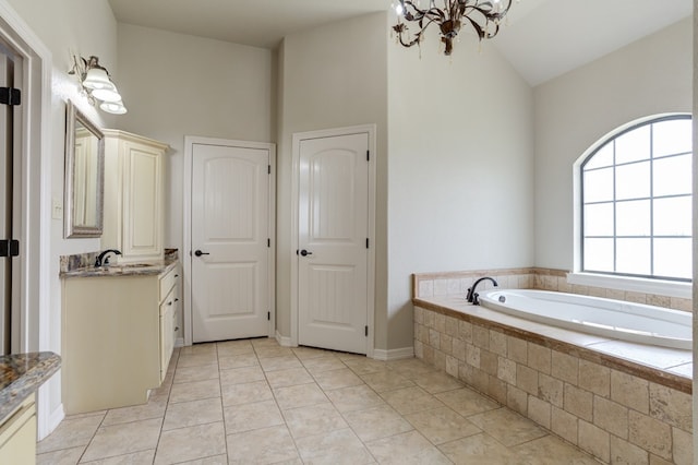 259 County Rd 304, Seminole, TX 79360 - full bathroom with a chandelier, tile patterned floors, vanity, a bath, and lofted ceiling