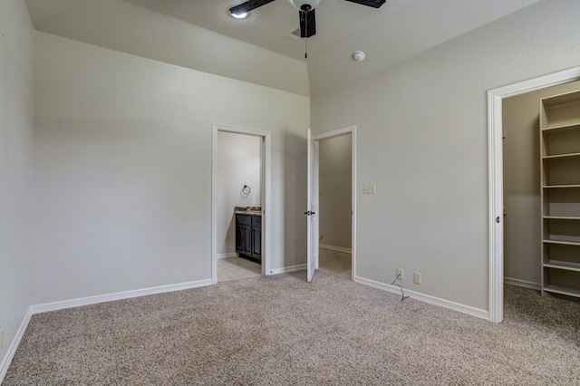 259 County Rd 304, Seminole, TX 79360 - unfurnished bedroom with a walk in closet, light colored carpet, and baseboards