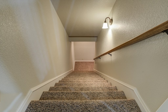 259 County Rd 304, Seminole, TX 79360 - stairway with carpet floors, a textured wall, and baseboards