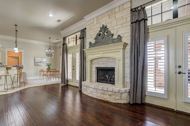 259 County Rd 304, Seminole, TX 79360 - living room with wood-type flooring, a chandelier, french doors, healthy amount of natural light, and ornamental molding