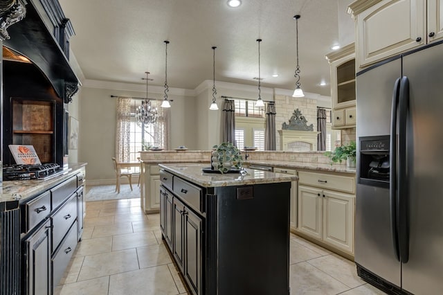 259 County Rd 304, Seminole, TX 79360 - kitchen with stainless steel appliances, cream cabinets, a peninsula, a chandelier, and plenty of natural light