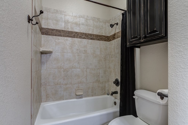 259 County Rd 304, Seminole, TX 79360 - bathroom with a textured wall, shower / bathtub combination with curtain, and toilet
