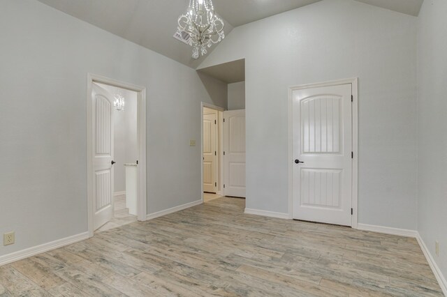 259 County Rd 304, Seminole, TX 79360 - unfurnished bedroom with a chandelier, wood finished floors, high vaulted ceiling, and baseboards