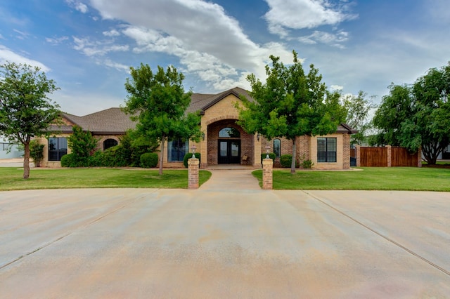 259 County Rd 304, Seminole, TX 79360 - view of front facade with french doors and brick siding