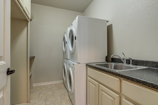259 County Rd 304, Seminole, TX 79360 - washroom with stacked washer / dryer, cabinet space, baseboards, and light tile patterned floors
