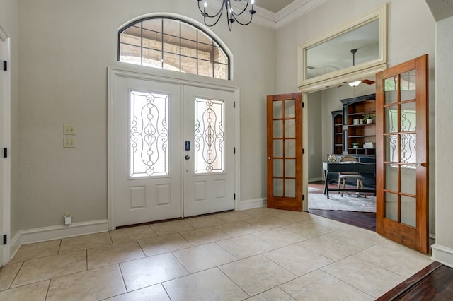 259 County Rd 304, Seminole, TX 79360 - foyer entrance with french doors, crown molding, a chandelier, tile patterned flooring, and a high ceiling
