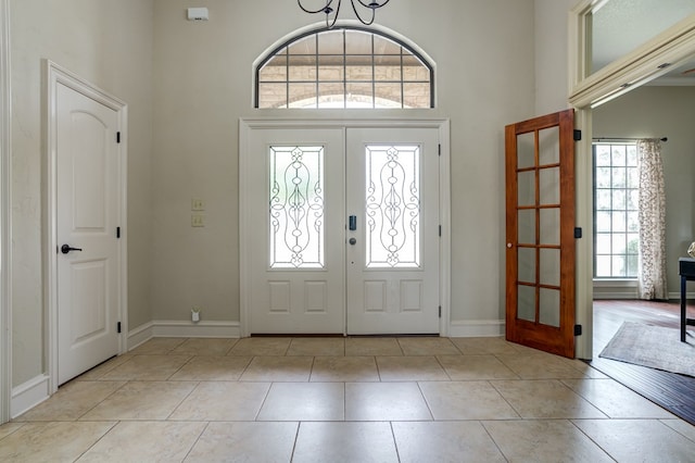 259 County Rd 304, Seminole, TX 79360 - entrance foyer featuring french doors, a towering ceiling, baseboards, and tile patterned flooring