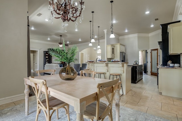259 County Rd 304, Seminole, TX 79360 - dining space with crown molding, arched walkways, recessed lighting, a chandelier, and light tile patterned floors