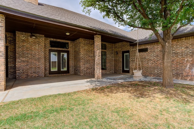 259 County Rd 304, Seminole, TX 79360 - doorway to property with brick siding, a lawn, and a patio area
