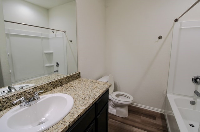 7319 W Pile Ranch Rd, Odessa, TX 79765 - bathroom with toilet, baseboards, wood finished floors, and tub / shower combination