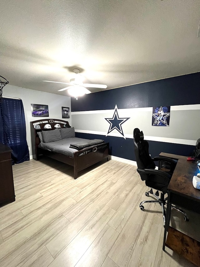bedroom with wood finished floors, a desk, a textured ceiling, and ceiling fan
