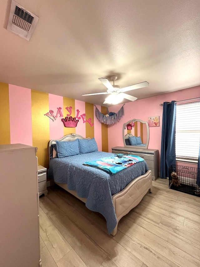 bedroom featuring light wood-type flooring and a ceiling fan
