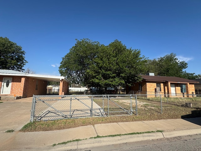 3811 Henderson Ave, Odessa, TX 79762 - view of front of home featuring driveway, an attached carport, a gate, and brick siding