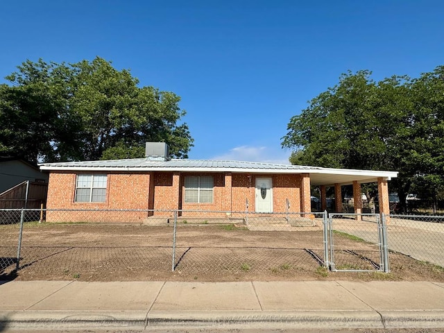 3811 Henderson Ave, Odessa, TX 79762 - single story home featuring brick siding, an attached carport, a fenced front yard, concrete driveway, and a metal roof