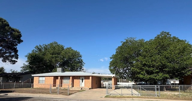 3811 Henderson Ave, Odessa, TX 79762 - view of front of house featuring a fenced front yard, a carport, concrete driveway, and a chimney