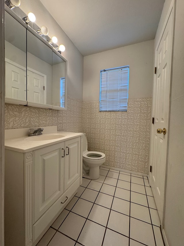3811 Henderson Ave, Odessa, TX 79762 - bathroom with vanity, tile patterned floors, and wainscoting