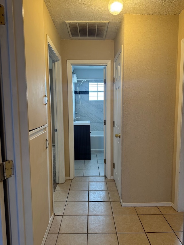 3811 Henderson Ave, Odessa, TX 79762 - hallway with light tile patterned floors and baseboards