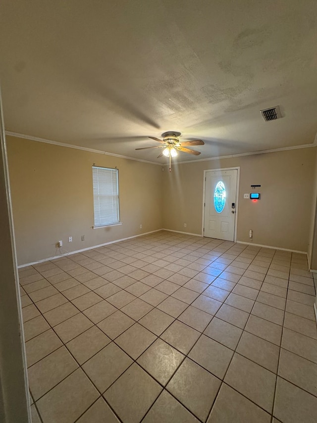 3811 Henderson Ave, Odessa, TX 79762 - empty room featuring light tile patterned floors, ornamental molding, a ceiling fan, and a textured ceiling