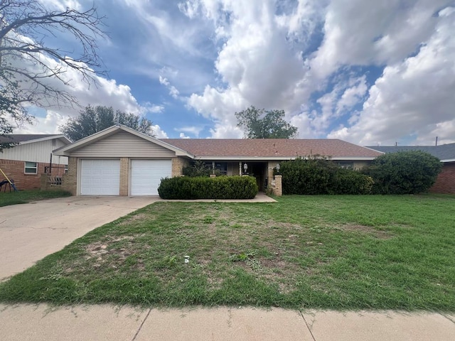 3805 E Everglade Ave, Odessa, TX 79762 - ranch-style home with concrete driveway, brick siding, a garage, and a front yard