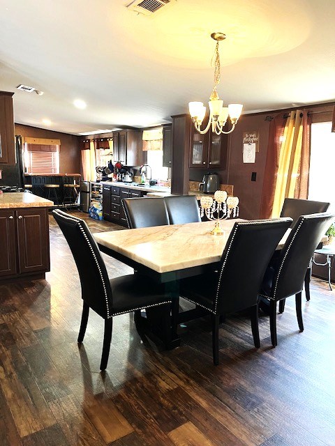 1319 S Broughton Ave, Odessa, TX 79761 - dining space featuring a chandelier and dark wood-type flooring